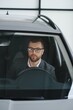 © Serhii - Handsome businessman driving car before buying
