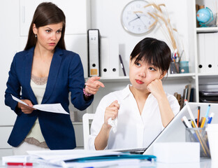 Wall Mural - Angry boss screaming to young female manager during working. High quality photo