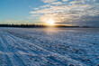 Sunset over winter fields in rural Canada.