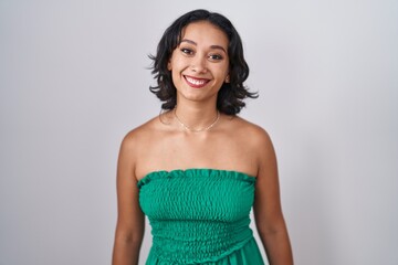 Wall Mural - Young hispanic woman standing over isolated background with a happy and cool smile on face. lucky person.