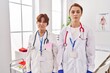 © Krakenimages.com - Two women wearing doctor uniform and stethoscope with serious expression on face. simple and natural looking at the camera.