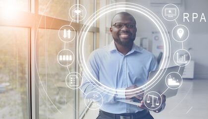 African-American businessman with laptop in office. RPA concept