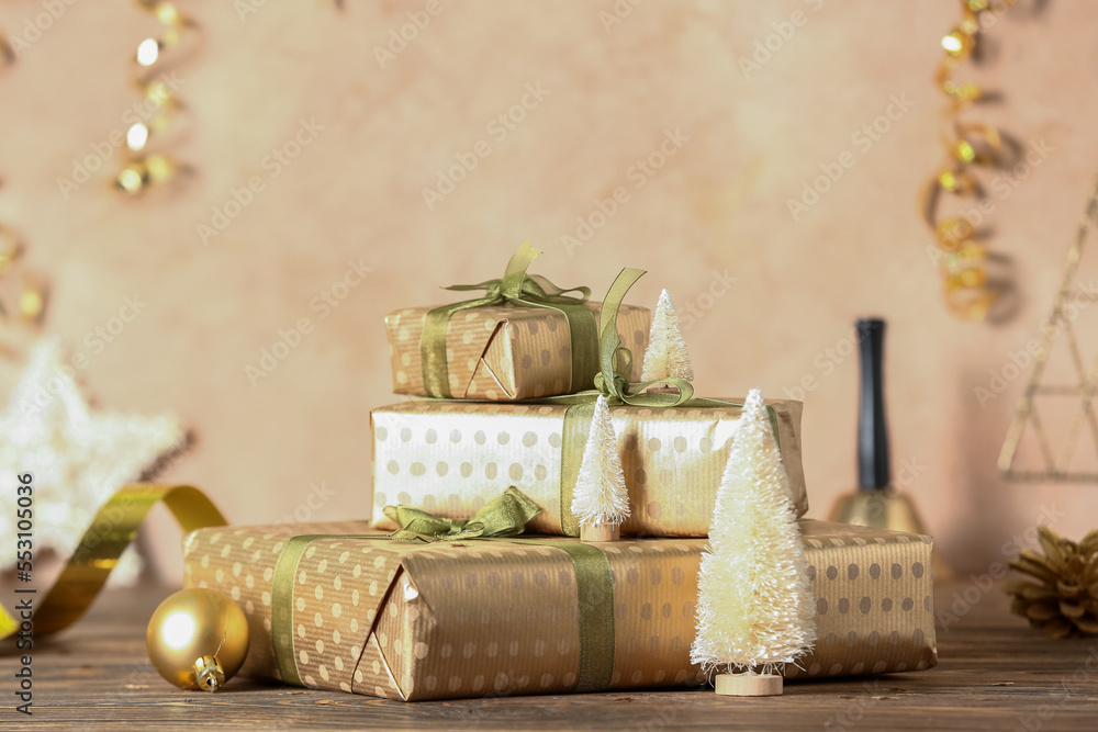 Stack of beautiful Christmas gifts and decorations on wooden table