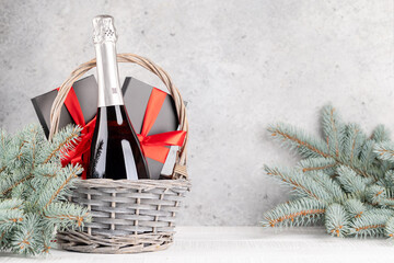 Wall Mural - Basket with Christmas gift boxes, champagne