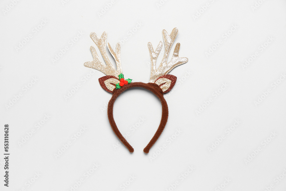 Funny Christmas reindeer horns on light background