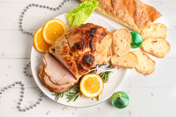 Plate with tasty ham, orange and Christmas decor on white wooden table