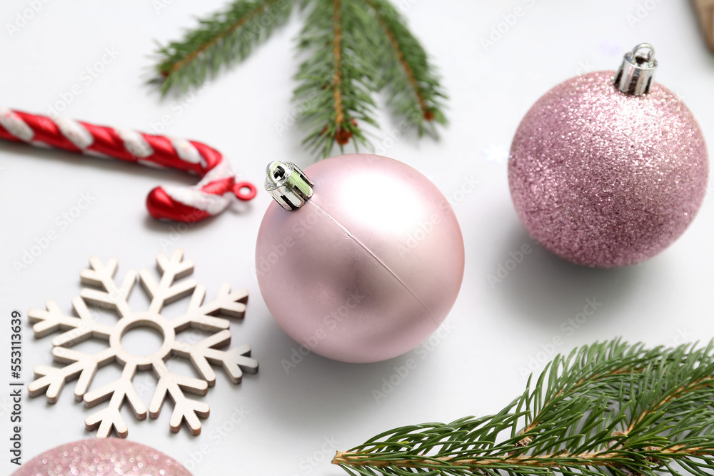 Beautiful Christmas decorations and fir branches on white background, closeup