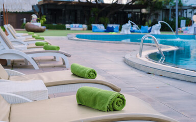 Wall Mural - beach chairs at a swimming pool with umbrellas, dek chair at a pool