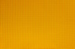 Orange abstract background. Natural cotton waffle fabric, cloth texture. Top view, close up.