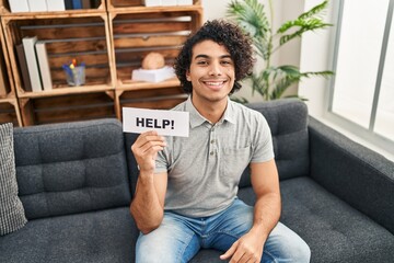 Canvas Print - Hispanic man with curly hair asking for help looking positive and happy standing and smiling with a confident smile showing teeth