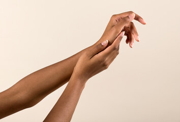 Wall Mural - gentle black female hands with natural manicure