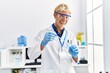 © Krakenimages.com - Young caucasian man wearing scientist uniform using pipette at laboratory