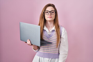 Sticker - Young caucasian woman working using computer laptop relaxed with serious expression on face. simple and natural looking at the camera.