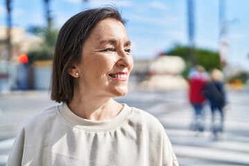 Wall Mural - Middle age woman smiling confident standing at street