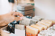 © Westend61 - Woman picking scented soap bar at zero waste shop