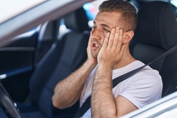 Canvas Print - Young caucasian man stressed driving car at street