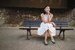 © Jacob Lund - Asian woman sitting on a city bench