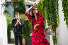 Flamenco Dancer Performing With Guitarist Near Wall