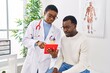 © Krakenimages.com - Man and woman doctor and patient having medical consultation using touchpad at clinic