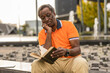 © Westend61 - Senior man with hand on chin reading book