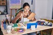 © Krakenimages.com - Young african american woman artist having online draw class at art studio