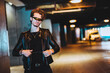 © Westend61 - Confident young man wearing smart glasses standing at illuminated underpass