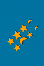 Three Dimensional Render Of Rows Of Yellow Stars And Crescent Moons Flat Laid Against Blue Background