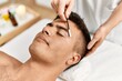 © Krakenimages.com - Young hispanic man relaxed having eyebrows treatment at beauty center
