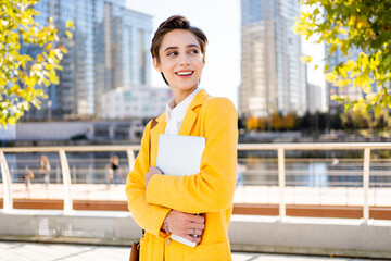 Beautiful young woman with short hair and colorful business suit - Corporate businesswoman on a business travel