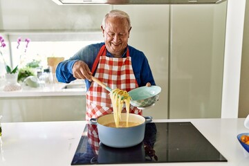 Poster - Senior man smiling confident cooking spaghetti at kitchen