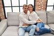 © Krakenimages.com - Man and woman couple smiling happy hugging each other at home