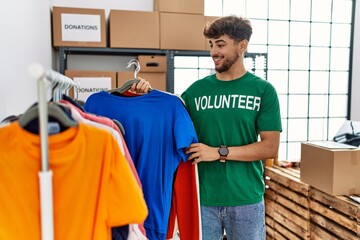 Sticker - Young arab man wearing volunteer uniform working at charity center