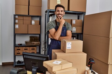 Poster - Young hispanic man business worker smiling confident standing at storehouse