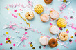 German Krapfen or donuts with streamers and confetti. Traditional Berliner for carnival and party