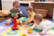 © Krakenimages.com - Group of toddlers playing with toys sitting on floor at kindergarten