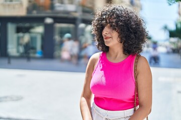 Sticker - Young middle eastern woman looking to the side with serious expression at street