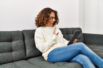 Canvas Print - Middle age hispanic woman smiling confident having video call at home