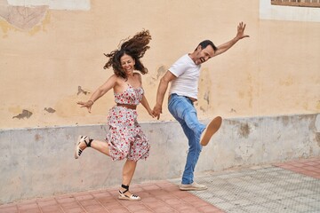 Poster - Man and woman couple smiling confident dancing at street