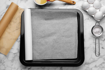 Canvas Print - Baking pan with parchment paper, different ingredients and kitchen tools on white marble table, flat lay. Space for text