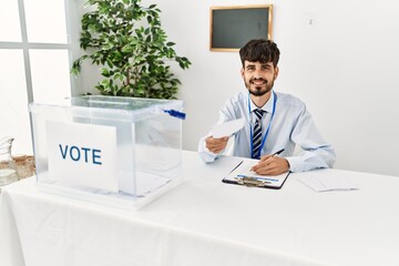 Sticker - Young hispanic politic party worker man working at electoral college.