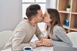 © Krakenimages.com - Man and woman couple using laptop and kissing at home