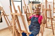 © Krakenimages.com - Senior african american woman listening to music drawing at art studio