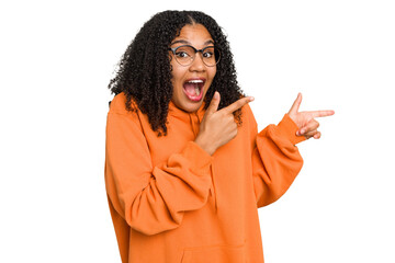 Wall Mural - Young african american woman with curly hair cut out isolated excited pointing with forefingers away.