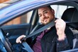 © Krakenimages.com - Young hispanic man wearing belt sitting on car at street