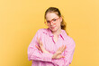 Young caucasian redhead woman isolated on yellow background doing a denial gesture