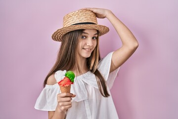 Sticker - Teenager girl holding ice cream smiling confident touching hair with hand up gesture, posing attractive and fashionable