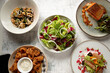 © Austockphoto - Looking down on 5 plates of different salad and seafood dishes