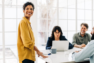 Canvas Print - black business woman having a meeting with her team in a boardroom