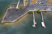 Aerial View Of Cars Parked At A Marina Carpark With Jettys And Pontoons