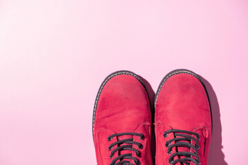Viva magenta color boots on colored background. Trendy color 2023. Variative focus